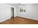 Bedroom features wood floors, a ceiling fan, and a bright window offering natural light at 3975 Coleridge Pl, Sarasota, FL 34241