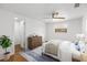 Cozy bedroom with wood floors, a ceiling fan, and ample natural light from a window at 3975 Coleridge Pl, Sarasota, FL 34241