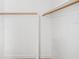 Walk-in closet with ample storage space and wooden rods at 3975 Coleridge Pl, Sarasota, FL 34241