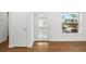 Bright entryway featuring wood floors, a frosted glass door, and a window with a view of the outdoors at 3975 Coleridge Pl, Sarasota, FL 34241
