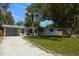 Lovely home with well-maintained lawn, beautiful palm trees, and a long gravel driveway at 3975 Coleridge Pl, Sarasota, FL 34241