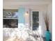 Inviting front entrance with a modern glass door, stylish light fixture, and a pop of color with a decorative vase at 3975 Coleridge Pl, Sarasota, FL 34241