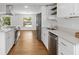 Bright, updated kitchen with stainless steel appliances, white cabinets, and wood-look flooring at 3975 Coleridge Pl, Sarasota, FL 34241