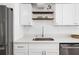 Bright and modern kitchen featuring quartz countertops, stainless steel appliances, and open shelving at 3975 Coleridge Pl, Sarasota, FL 34241