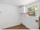 Bright laundry room with a storage cabinet and a window bringing in natural light at 3975 Coleridge Pl, Sarasota, FL 34241