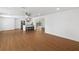 Spacious living room with wood floors, a ceiling fan, and an open view of the adjacent kitchen at 3975 Coleridge Pl, Sarasota, FL 34241