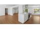 Spacious and bright living area with wood floors flowing into a modern kitchen at 3975 Coleridge Pl, Sarasota, FL 34241