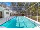 Refreshing screened-in pool surrounded by lush landscaping, creating a private and tranquil retreat at 3975 Coleridge Pl, Sarasota, FL 34241
