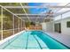 Relaxing screened-in pool area with lounge chairs and well-maintained pool, perfect for outdoor enjoyment at 3975 Coleridge Pl, Sarasota, FL 34241