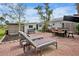 A backyard featuring a brick patio with outdoor furniture and a storage shed at 404 Bayshore Rd, Nokomis, FL 34275