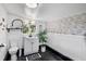 Charming bathroom with stylish fixtures, beach decor, and attractive wallpaper at 404 Bayshore Rd, Nokomis, FL 34275