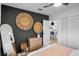 Comfortable bedroom featuring a sleek dresser, black accent wall, and doorway to another room at 404 Bayshore Rd, Nokomis, FL 34275