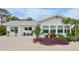 Charming single story home with a manicured front yard featuring colorful landscaping and updated windows at 404 Bayshore Rd, Nokomis, FL 34275