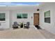Inviting front porch with Adirondack chairs, pea gravel and a stylish wood front door at 404 Bayshore Rd, Nokomis, FL 34275