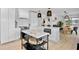 Modern kitchen featuring a quartz island, stainless appliances, and an open layout leading to dining area at 404 Bayshore Rd, Nokomis, FL 34275