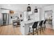 Bright kitchen featuring a quartz island, stainless appliances, and modern pendant lighting at 404 Bayshore Rd, Nokomis, FL 34275