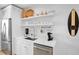 Updated kitchen with stainless steel appliances, white cabinetry, and quartz countertops and open shelving at 404 Bayshore Rd, Nokomis, FL 34275
