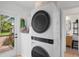 A modern laundry room featuring stacked washer and dryer units and convenient access to outdoor views at 404 Bayshore Rd, Nokomis, FL 34275