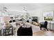 Airy living room featuring a cozy couch, a ceiling fan, and lots of natural light streaming through multiple windows at 404 Bayshore Rd, Nokomis, FL 34275