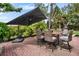 An outdoor patio set under a large umbrella with room for entertaining at 404 Bayshore Rd, Nokomis, FL 34275