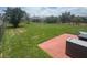 Wide shot of the fenced in backyard, green grass and view of surrounding homes at 4077 River Bank Way, Punta Gorda, FL 33980