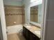 Bathroom featuring double sinks with granite countertops and a tiled shower-tub combo at 4077 River Bank Way, Punta Gorda, FL 33980