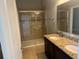 Bathroom with double sink vanity, granite countertop, and glass enclosed tiled shower at 4077 River Bank Way, Punta Gorda, FL 33980