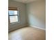 Bright bedroom with neutral walls, tile flooring, and a window with blinds at 4077 River Bank Way, Punta Gorda, FL 33980