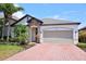 Charming single Gathering home featuring brick driveway, stone accents, and a well-manicured lawn at 4077 River Bank Way, Punta Gorda, FL 33980