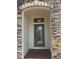 Inviting front entrance with stone archway and decorative glass door at 4077 River Bank Way, Punta Gorda, FL 33980