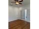 Hardwood floors and ceiling fan in a bright and airy living room with access to other rooms at 4077 River Bank Way, Punta Gorda, FL 33980