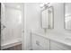 Modern bathroom with a glass shower, quartz countertop, and gold faucet at 4318 Marina View Way, Cortez, FL 34215