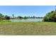 Open backyard overlooking a serene pond, enhanced by lush natural surroundings at 4484 Tortoise Rd, Venice, FL 34293
