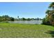 Expansive backyard view overlooking a tranquil pond and lush greenery at 4484 Tortoise Rd, Venice, FL 34293