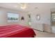 Bright bedroom with water view, ceiling fan, and wicker dresser at 4484 Tortoise Rd, Venice, FL 34293