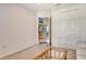 Neutral-toned bonus room with carpet and a peek into an adjacent room with coastal decor at 4484 Tortoise Rd, Venice, FL 34293