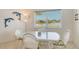 Bright dining area with white wicker table and chairs and a view of the water at 4484 Tortoise Rd, Venice, FL 34293