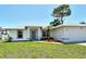 Charming single-story home with a well-maintained lawn, mature trees, and an attached two-car garage at 4484 Tortoise Rd, Venice, FL 34293