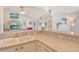 Open kitchen with breakfast bar and tile flooring, open to living area at 4484 Tortoise Rd, Venice, FL 34293