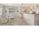 Bright kitchen and breakfast nook with white cabinetry and tile flooring at 4484 Tortoise Rd, Venice, FL 34293