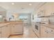 Open kitchen with bright white appliances, tile floors and breakfast bar at 4484 Tortoise Rd, Venice, FL 34293