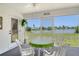 Enclosed lanai overlooking the lake featuring a table and chairs for outdoor dining at 4484 Tortoise Rd, Venice, FL 34293