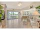 Bright living room featuring tile floors, vaulted ceilings, and a sliding glass door to the lanai at 4484 Tortoise Rd, Venice, FL 34293