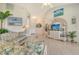Cozy living room with tile floors, a vaulted ceiling, and a decorative TV stand at 4484 Tortoise Rd, Venice, FL 34293