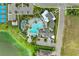 A stunning community aerial featuring a resort-style pool, clubhouse, tennis courts, and lush landscaping at 4625 Canoe Creek Ave, Parrish, FL 34219