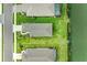 Bird's eye view showcasing the home's roof, landscaping, and backyard leading to the water at 4625 Canoe Creek Ave, Parrish, FL 34219