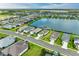 Aerial view of a beautiful community and waterfront homes surrounding a picturesque lake at 4625 Canoe Creek Ave, Parrish, FL 34219