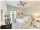Bedroom with ceiling fan, decorated mirror, and lots of natural light at 4625 Canoe Creek Ave, Parrish, FL 34219
