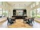 Stylish clubhouse kitchen with island seating, tables, chairs, and stainless appliances for entertaining at 4625 Canoe Creek Ave, Parrish, FL 34219