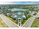 Beautiful community center with a swimming pool, tennis courts, lush landscaping, and stunning lake views at 4625 Canoe Creek Ave, Parrish, FL 34219